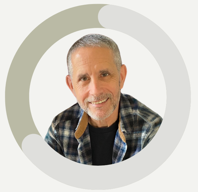 Author Gregory P. Steffine wearing a plaid shirt with a circular frame around him on a white background